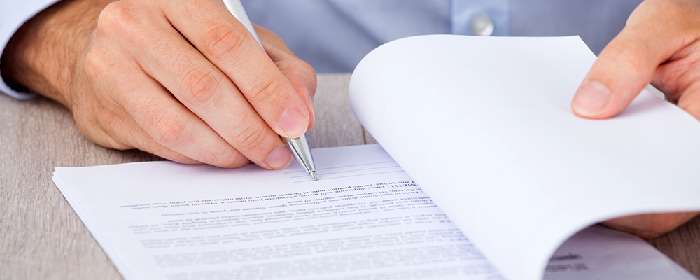 person writing in a document person writing in a document